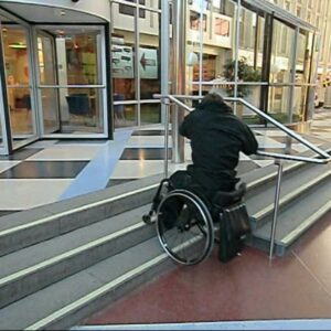 Go down a flight of stairs with handrail in a wheelchair